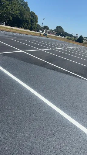 Fresh parking lot line striping on asphalt surface