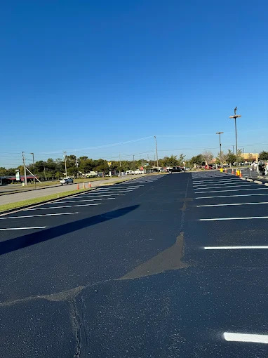 Freshly sealcoated asphalt driveway and parking area